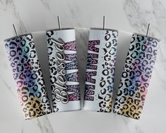 three toothbrushes with different designs on them sitting next to each other in front of a marble surface