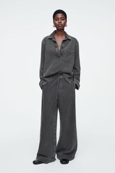 WIDE-LEG FLUID DENIM TROUSERS - WASHED BLACK - COS Washed Pants For Workwear In Fall, Fall Workwear Washed Pants, Spring Workwear Pants In Washed Black, Washed Black Relaxed Fit Work Pants, Relaxed Fit Washed Pants For Work, Relaxed Fit Wide-leg Washed Pants, Wide Leg Workwear Bottoms, Washed Black Bottoms With Straight Hem For Workwear, Oversized Washed Wide Leg Pants