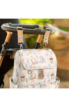 a baby stroller with a diaper bag attached to it's handlebars