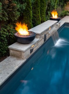 a fire pit sitting next to a swimming pool