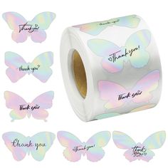 a roll of thank you stickers with pastel butterflies on them and the words thank you