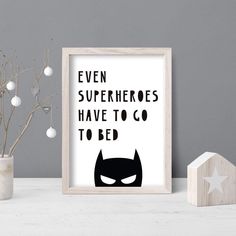 a batman poster with the words even superheros have to go to bed on it