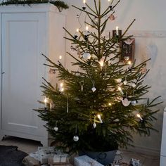 a small christmas tree with presents under it