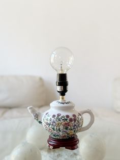 a teapot with a light bulb on top of it