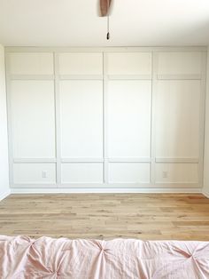 an empty room with white walls and wood flooring is pictured in this image, there are no people or furniture