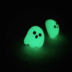 two glowing ghost heads in the dark