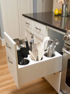 an appliance drawer is open to show the kitchen utensils in it