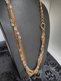 Add a touch of glamour to any outfit with this stunning multi-tone gold chain necklace. The necklace features multiple chains of varying widths, adorned with beautiful beads that add texture and depth to the piece. Measuring at 27 inches in length, it has a spring ring closure for easy wear. This vintage necklace is perfect for any occasion, including weddings, birthdays, and graduations. The necklace comes with no stone or gemstones and has a pendant shape that doesn't apply. The multi-chain ne Gold Beaded Long Chain Necklace, Gold Long Beaded Chain Necklace, Long Gold Beaded Chain Necklace, Gold Double Strand Chain Necklace With Beads, Double Strand Gold Chain Necklace With Beads, Elegant Gold Layered Necklace With Beaded Chain, Elegant Multi-strand Chain Necklace With Gold Beads, Gold Multi-strand Beaded Chain Necklace, Multi-strand Gold Beaded Necklaces For Jewelry Making