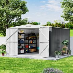 a shed with its doors open on the grass and plants in pots next to it