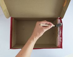 a person is holding a brush in a box