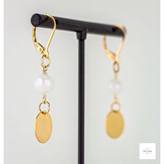 Mystic moonstone gold disc drop earrings from Miel Jewelry! These cute earrings are a modern and stylish addition to any outfit. The smooth and shimmery white mystic moonstone beads are so sweet and pretty! They are paired perfectly with these gold-plated circular drops. They have gold-plated sterling silver lever backs for a secure and comfortable fit. 1.75 inches in length. If you are looking for the perfect gift or just want to treat yourself, these lightweight and shimmery Mystic moonstone g Minimalist Moon Charm Drop Earrings, Elegant Moonstone Moon Charm Jewelry, Elegant Moonstone Jewelry With Moon Charm, Elegant Gold Earrings With Moon Charm, Elegant Moon-shaped Moonstone Jewelry, Elegant Moon Shaped Moonstone Jewelry, Elegant Gold Moon-shaped Earrings, Elegant Brass Earrings With Moon Charm, Moonstone Earrings With Moon Charm