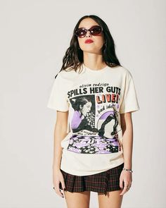 a woman wearing sunglasses and a t - shirt that says spill's her guts live