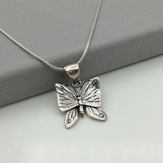 ▪︎ A sterling silver butterfly pendant with movable lower wings. ▪︎ Size: 18mm x 20 mm . Weighs: 3.8 gm ▪︎ This multi purpose pendant can be used as a charm in necklaces, bracelets, key chains, zip pullers etc. ▪︎ This pendant is handmade with hypoallergenic sterling silver. Most of my pieces are marked with a 925 silver stamp. ▪︎ Please note: This listing is for ONE pendant and comes WITHOUT the chain, however, you can add a snake chain in the required length while making your selection. You ca Unique Silver Butterfly Pendant Necklace, Unique Silver Butterfly Necklace, Butterfly Pendant Necklace As A Gift, Butterfly Shaped Necklace With Large Pendant, Butterfly Pendant Necklace For Gifts, Butterfly Pendant Necklace For Gift, Handmade Silver Butterfly Necklace, Unique Handmade Silver Butterfly Necklace, Unique Sterling Silver Jewelry With Butterfly Charm