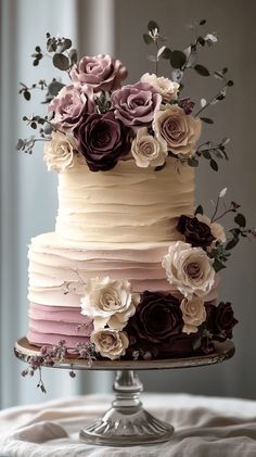 a multi layer cake with flowers on top