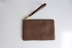 The cute woven clutch purse you'll want to take everywhere. This simple wristlet is made from a unique woven material that mimics the look of woven straw without the flimsy feel. Durable, lightweight and sized just right. Brown Clutch With Braided Handles For Everyday Use, Everyday Rectangular Clutch With Braided Handles, Brown Leather Clutch With Braided Handles For Daily Use, Everyday Clutch With Braided Handles, Everyday Handwoven Rectangular Clutch, Rectangular Handwoven Clutch, Brown Rectangular Clutch With Braided Handles, Chic Brown Woven Clutch, Brown Pouch Clutch With Braided Handles