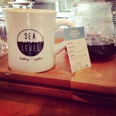 a coffee mug sitting on top of a wooden tray