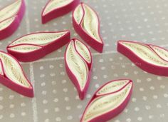 some pink and white leaves on a table