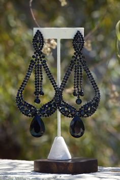 "Oversized statement earrings. These fun and stylish chandelier earrings, in black rhinestones, make a great statement piece for on stage or photos! Size of earrings: 2 3/4\" Wide and 5 1/2\" Long. Color: Black Base Metal: silver More colors available! Just message us! Style: Pierced and clip on available Looking for a matching bracelet? https://www.etsy.com/listing/556673735/crystal-wide-bracelet-royal-blue?ref=shop_home_active_9 Looking for the perfect pair of earrings for a special occasion. Large Black Chandelier, Stylish Chandelier, Pageant Earrings, Unique Chandeliers, Fun Ornaments, Wide Bracelet, Black Chandelier, Earrings Long, Black Rhinestone