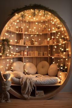 a circular bed with lights on it and a teddy bear sitting in front of the bed