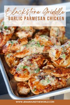 grilled chicken with garlic and parmesan sauce in a metal pan on top of a table