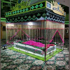 an elaborately decorated bed in the middle of a large room with flowers on it