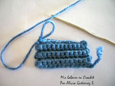 a crocheted blue object with yarn next to it