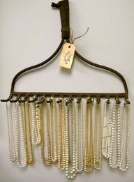 a hanger with beads hanging from it's side and a tag that says unique necklace displays