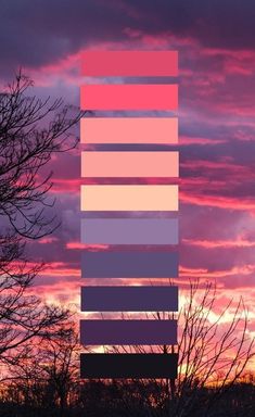 the sky is pink, purple and blue with some trees in front of it at sunset