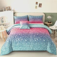 a bed with blue and pink bedspread in a room