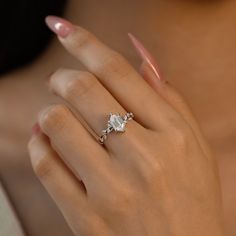 a woman's hand with a diamond ring on it