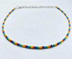 This rainbow beaded choker is made with 12/0 glass seed beads.  It is 12 inches long and comes with a 2 inch extender chain. It is a standard lobster clasp.  If you would like it to be bigger or smaller, just let me know! Rainbow Beaded Choker With Round Beads, Rainbow Round Beads Adjustable Choker, Adjustable Rainbow Choker With Round Beads, Adjustable Rainbow Beaded Choker Necklaces, Adjustable Rainbow Beaded Choker, Rainbow Beaded Necklace, Minimalist Rainbow, Rainbow Choker, Choker Handmade