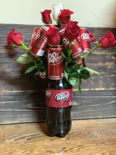 a beer bottle with roses in it sitting on a table