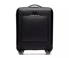 a black suitcase with wheels and handles on the bottom, in front of a white background