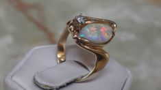 I cut and shaped this beautiful Australian opal to fit in to this heavy14k solid yellow gold ring which I found at an antique store. The ring is a size 6 1/8 U.S.   That opal weighs 2.0 carats. The bright accent diamond is 3mm. and weighs 0.3 carats. I will size the ring for you at no additional cost.   #S 202 Antique Store, Oct 1, Opal Ring, Yellow Gold Ring, Australian Opal, Antique Stores, 3 Carat, Opal Pendants, Opal Rings