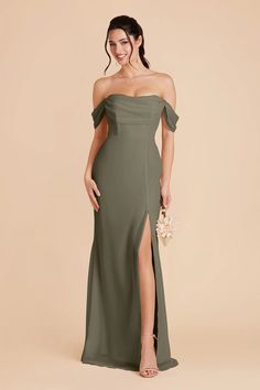 a woman in a long green dress with an off the shoulder slit and side split