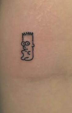 a small cartoon character tattoo on the back of a woman's left arm,