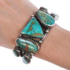 6 3/8" Vintage Royston Turquoise Native American Silver bracelet 1.25" or 33 mm
wide in center, weight and other measurements in pics, no issues, unmarked or
marked as shown. If a mark isn't shown then it isn't marked..

All precious metals are tested and guaranteed, any Native American jewelry
referred to as Silver or Sterling is guaranteed to be a minimum of 90% (coin)
silver and possibly higher content. Anything marked is guaranteed to be what
it's marked, most bracelets are photographed on a 6" wrist (non hairy), rings
photographed on the appropriate sized finger when possible. With bracelets if
the measurement is not given in the description then inside circumference is
shown where the metal meets the number on the the cloth tape measure. Turquoise Patina Bracelet, Turquoise Patina Bracelet Jewelry, Turquoise Chrysocolla Bracelet, Vintage Native American Jewelry, Turquoise Jewelry Native American, Cloth Tape, Royston Turquoise, Handcrafted Artisan Jewelry, Vintage Turquoise