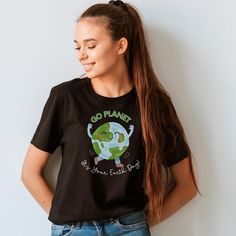 a girl with long hair wearing a black t - shirt that says go plant it