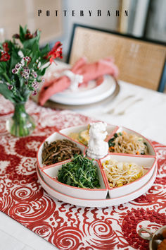 a table topped with plates and bowls filled with different types of food on top of it