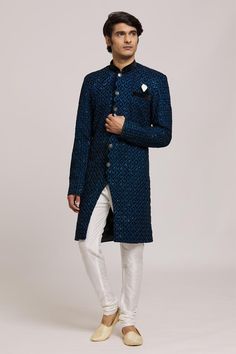 Blue sherwani with embroidered floral jaali patterns embellished with sequins. Comes with churidar.
Components: 2
Pattern: Embroidered
Type Of Work: Floral
Neckline: Mandarin Collar
Sleeve Type: Full
Fabric: Sherwani: Neel Velvet, Churidar: Silk Dupion
Color: Blue
Other Details: 
Embellished buttons
Closure:
Sherwani: Front button
Churidar: Drawstring
Note: Pocket square worn by the model is not for sale
Occasion: Sangeet,Mehendi and Puja - Aza Fashions Velvet Churidar, Blue Sherwani, Embroidered Sherwani, Embellished Buttons, Churidar, Mandarin Collar, Pocket Square, Aza Fashion, Sleeve Type