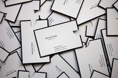 many business cards are stacked together on top of each other