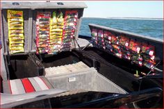 the back end of a boat filled with boxes and snacks on it's side