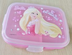 a pink lunch box with a barbie doll on it