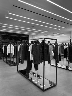 an empty clothing store with clothes on racks