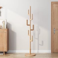 a wooden coat rack in the corner of a room