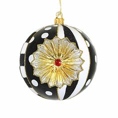 a black and white christmas ball ornament with gold trimmings on it