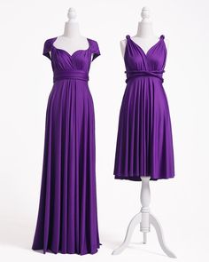 two mannequins dressed in purple dresses on display