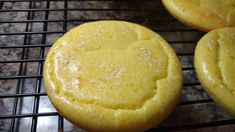 three yellow cookies cooling on a wire rack