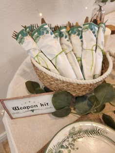 a basket filled with napkins sitting on top of a table next to a plate