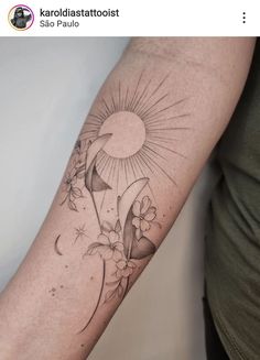 a woman's arm with a tattoo on it that has flowers and the sun